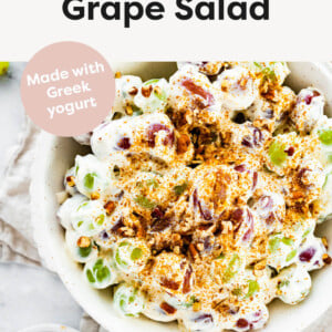 Serving bowl with grape salad topped with sugared pecans.