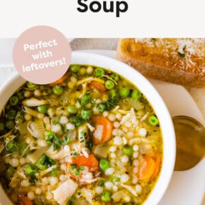 Bowl of Turkey Soup with a spoon and slice of crusty bread next to the bowl.