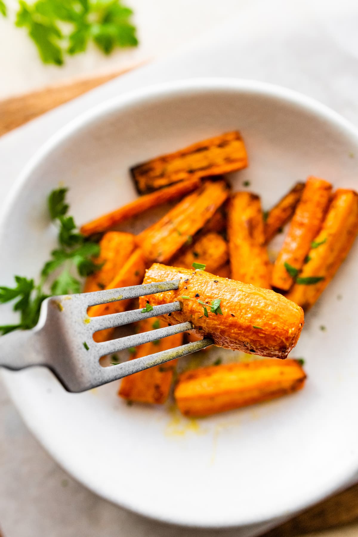 A fork holding an air fried carrot.