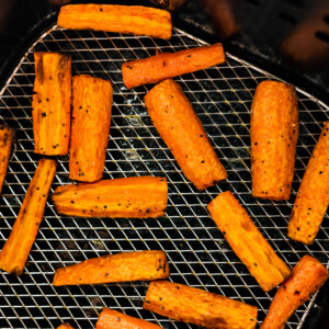 Carrots cut into matchsticks in an air fryer.