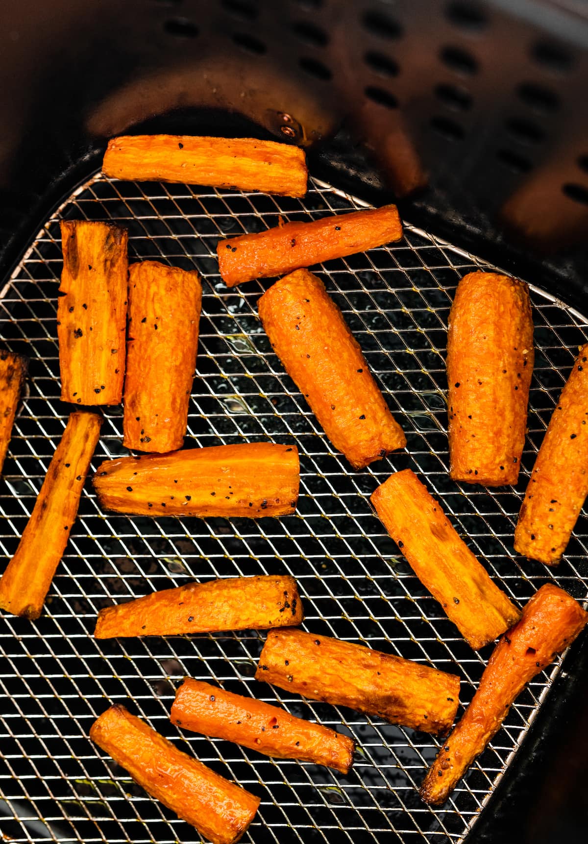 Carrots cut into matchsticks in an air fryer.