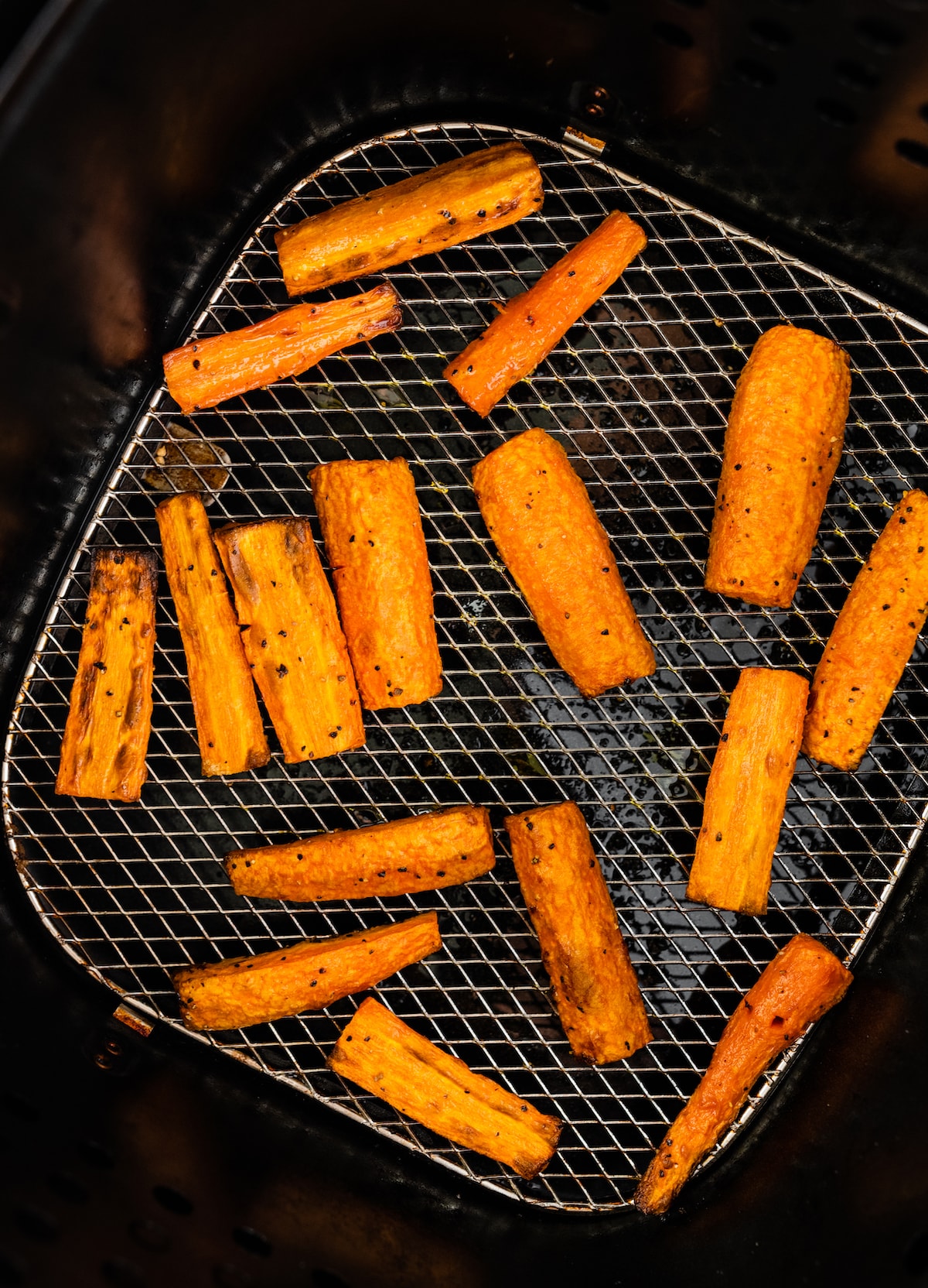 Carrots cut into matchsticks in an air fryer.