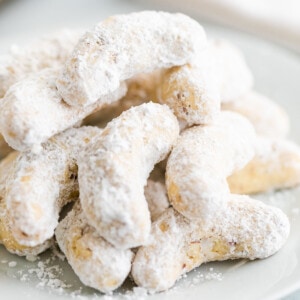 Almond crescent cookies on a plate.