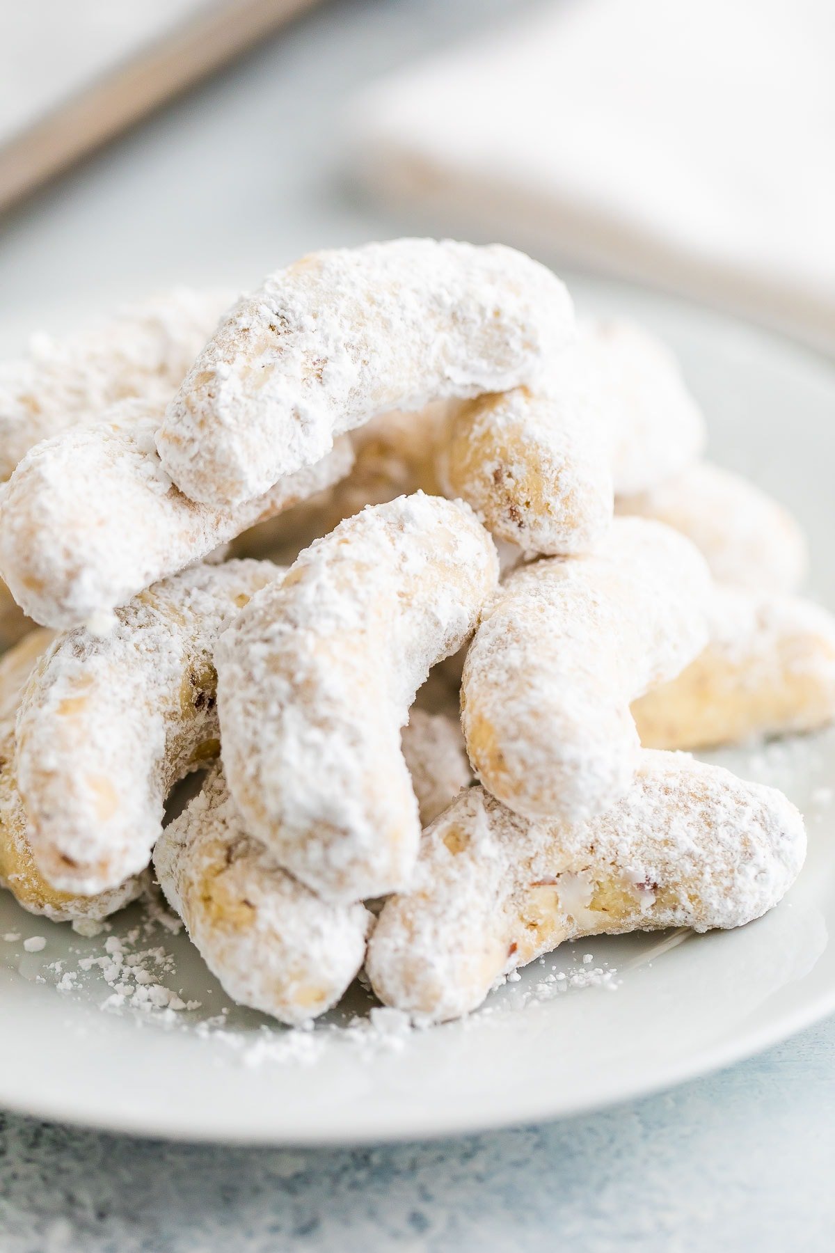 Almond crescent cookies on a plate.