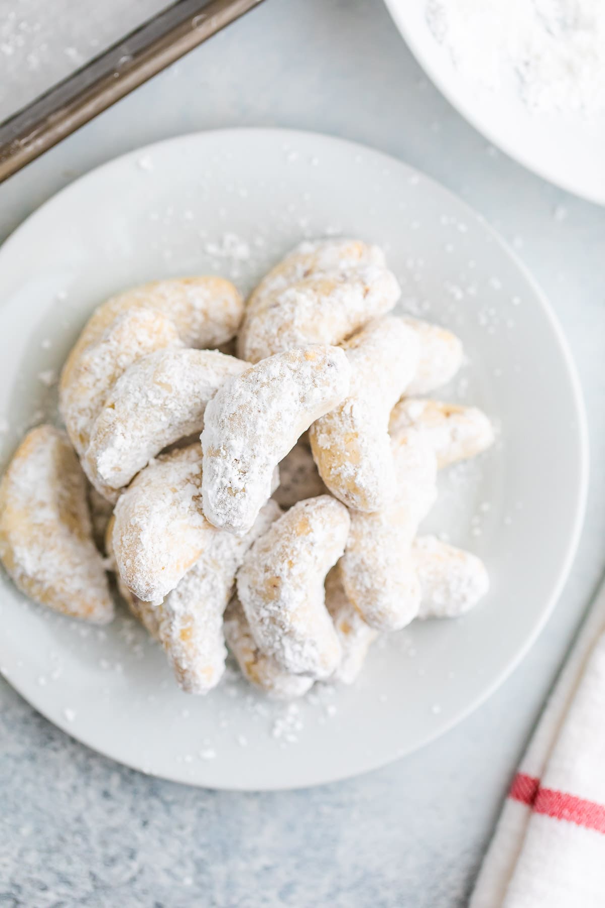Almond crescent cookies on a plate.
