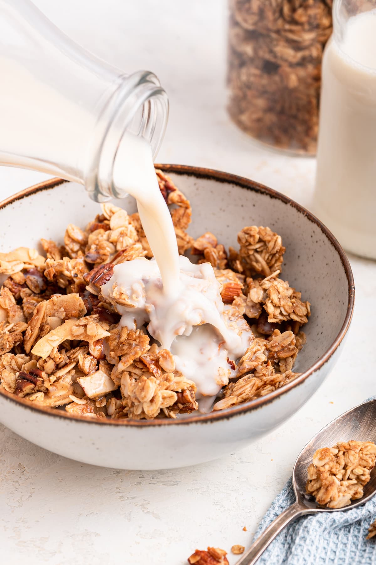 Milk being poured into a bowl of homemade granola.