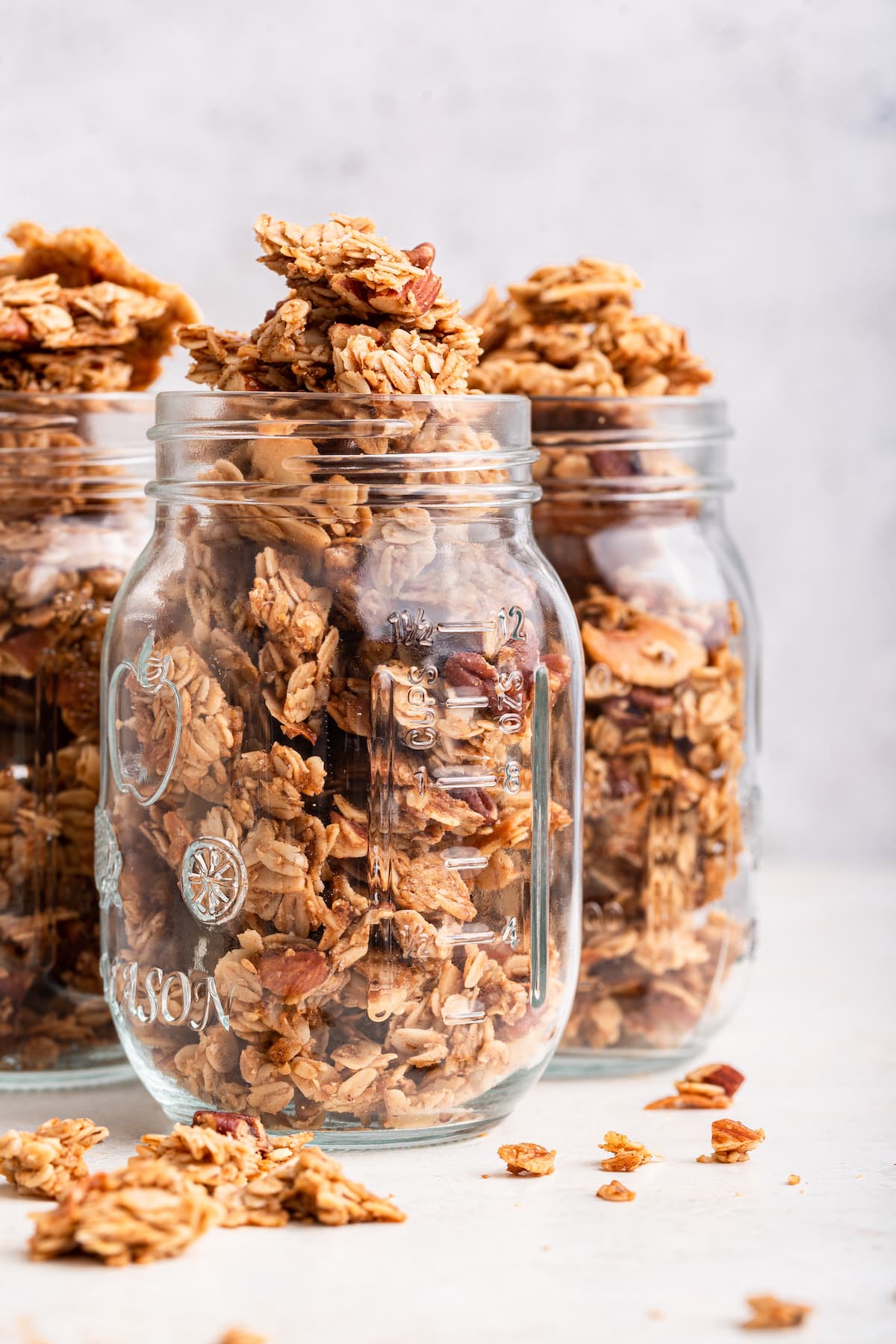 Three glass mason jars containing homemade granola.