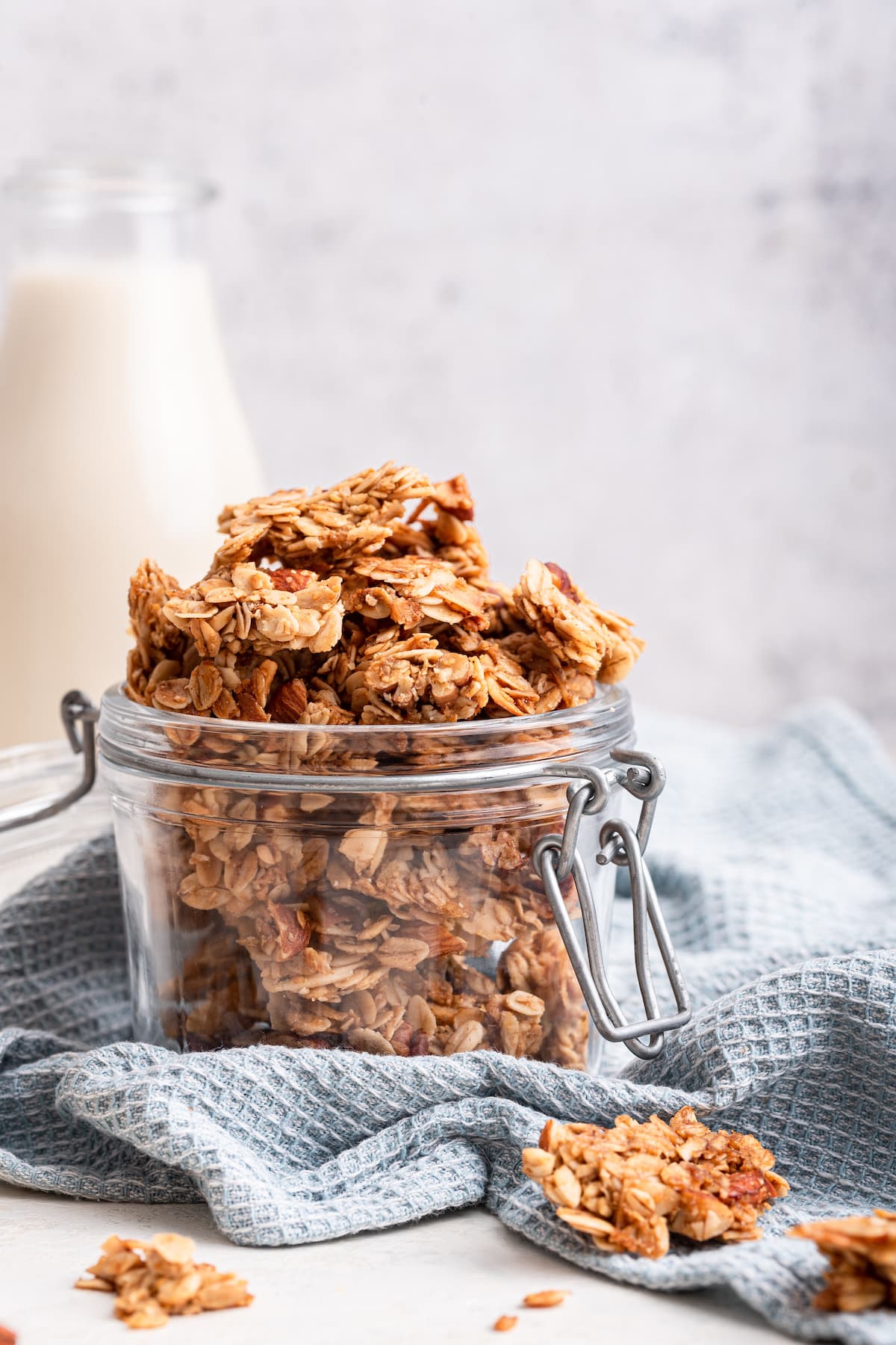 A small glass jar with homemade granola inside.