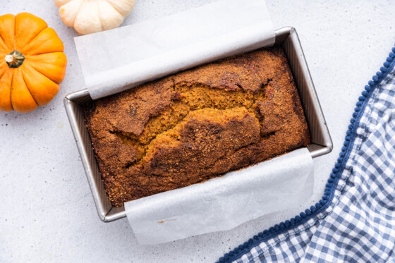 Healthy pumpkin bread in a loaf pan after being baked.