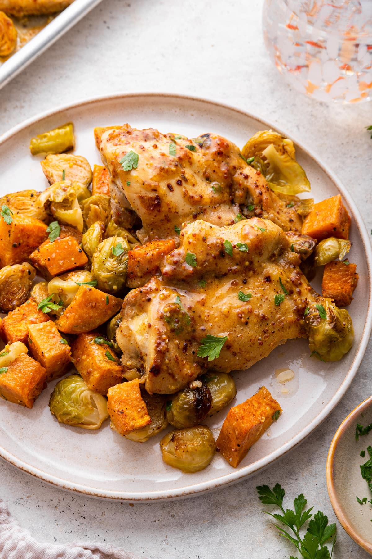 Honey mustard chicken sheet pan meal with roasted vegetables on a large plate.