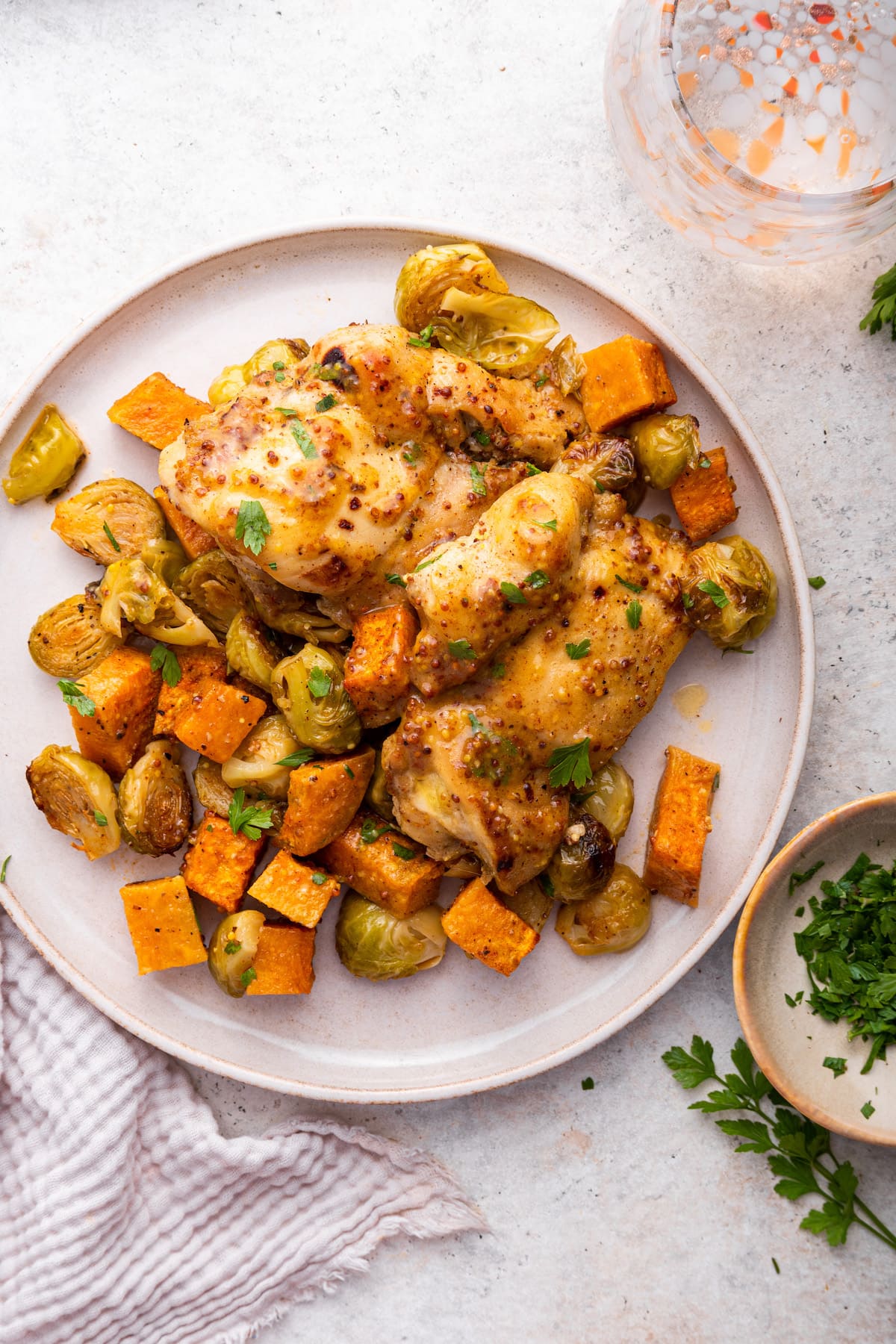 Honey mustard chicken sheet pan meal with roasted vegetables on a large plate.