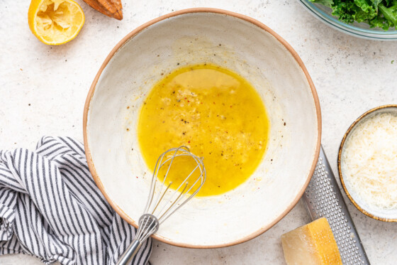 The lemon dressing for the kale salad mixed together in a serving bowl.