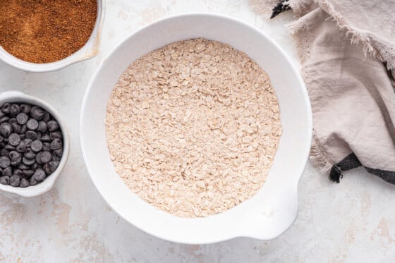 Rolled oats in a large white mixing bowl.