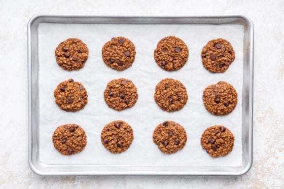 Twelve lactation cookies on a baking sheet after being baked in the oven.