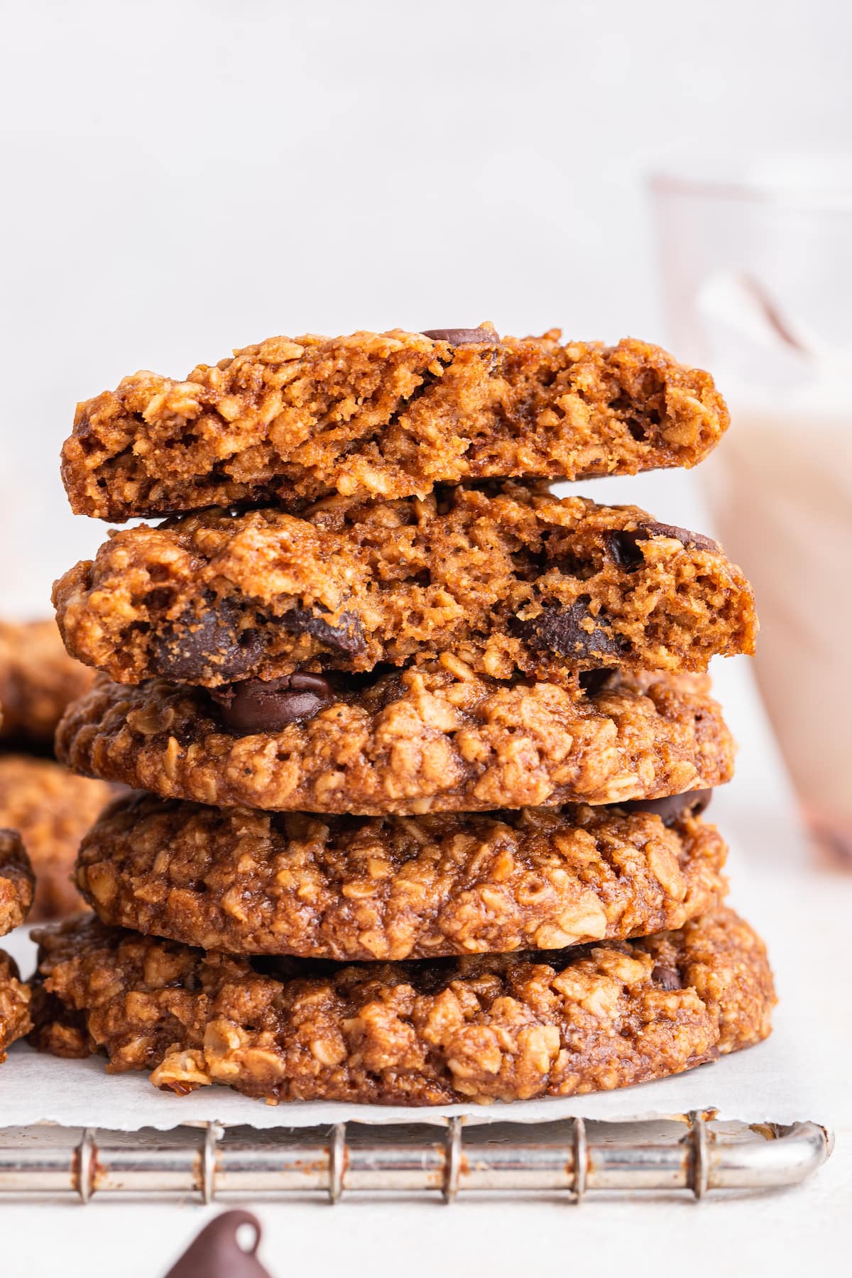 Five lactation cookies stacked on one another with a bite taken from the top two.