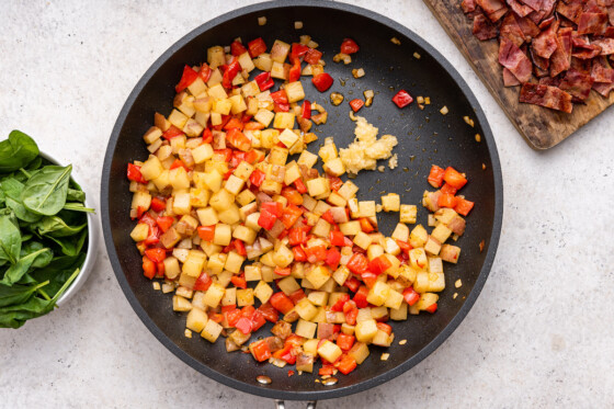 Diced bell pepper and potatoes in a large skillet.
