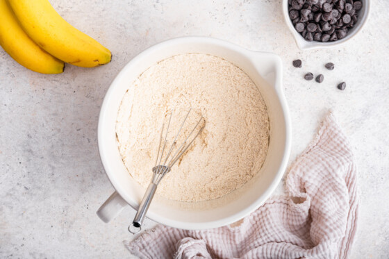 Flour in a large mixing bowl with a metal whisk.