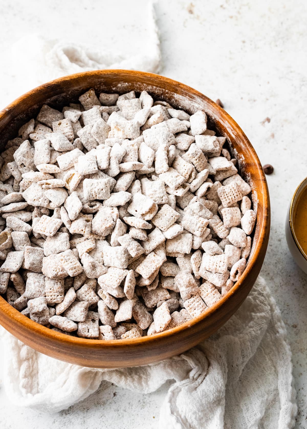 Puppy chow in a large wooden bowl.