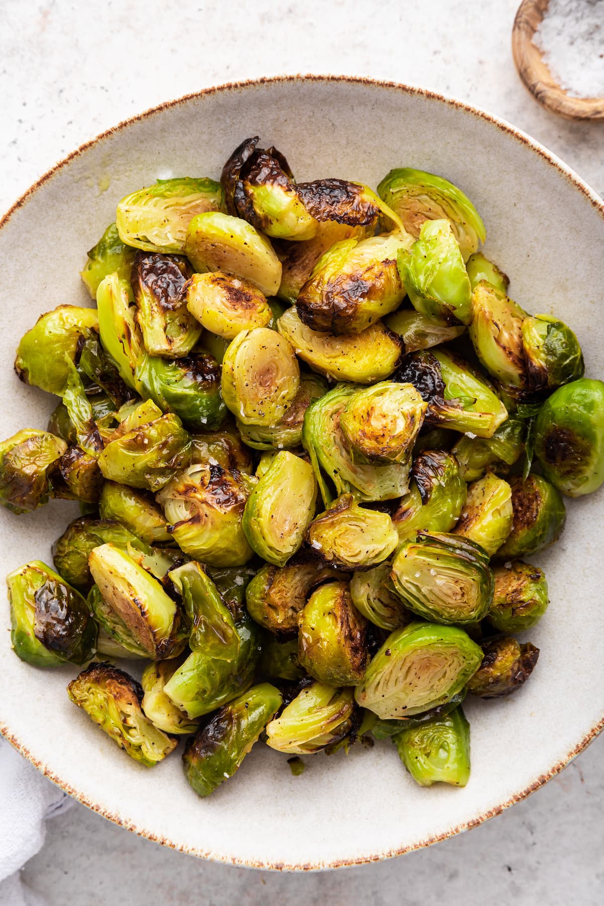 Roasted brussels sprouts in a large serving bowl.