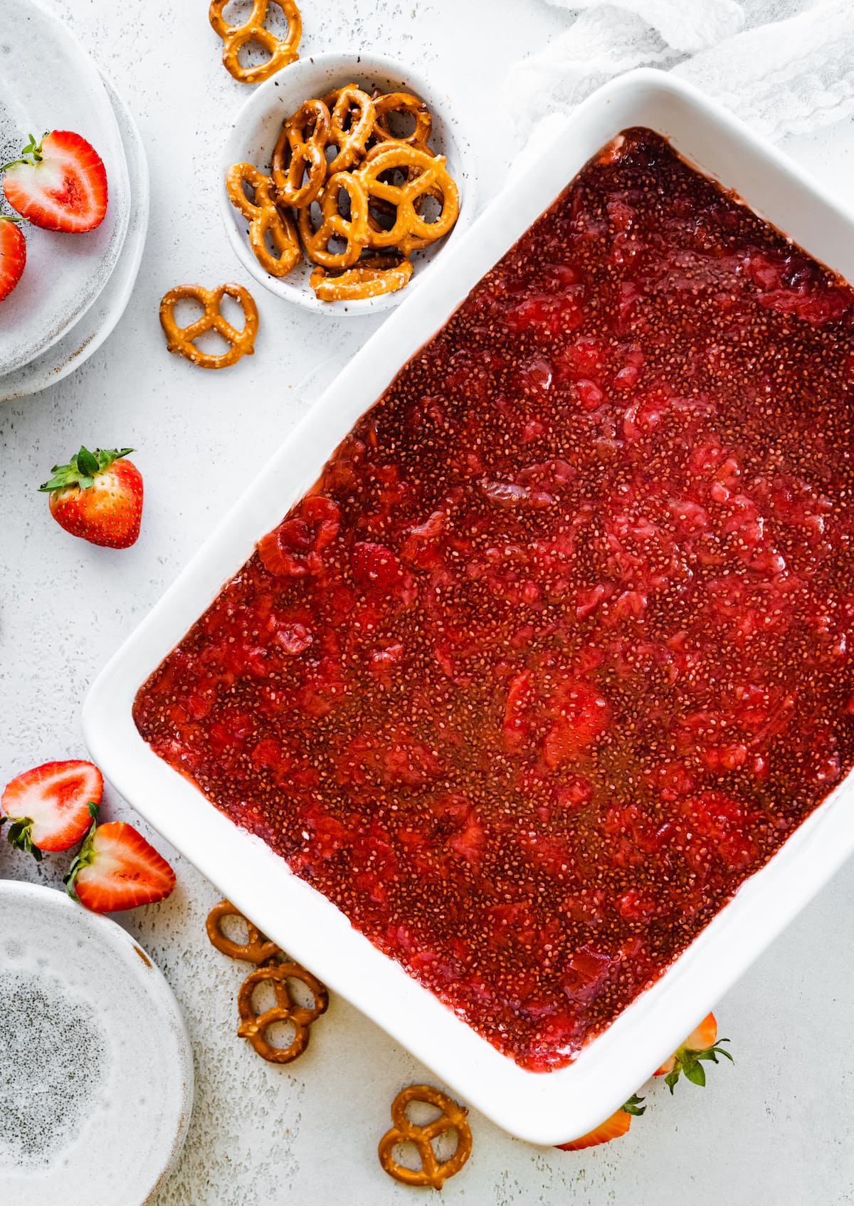 A layer of strawberry chia jam spread out in a large baking pan.