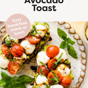 Avocado toast topped with basil, mozzarella and cherry tomatoes.