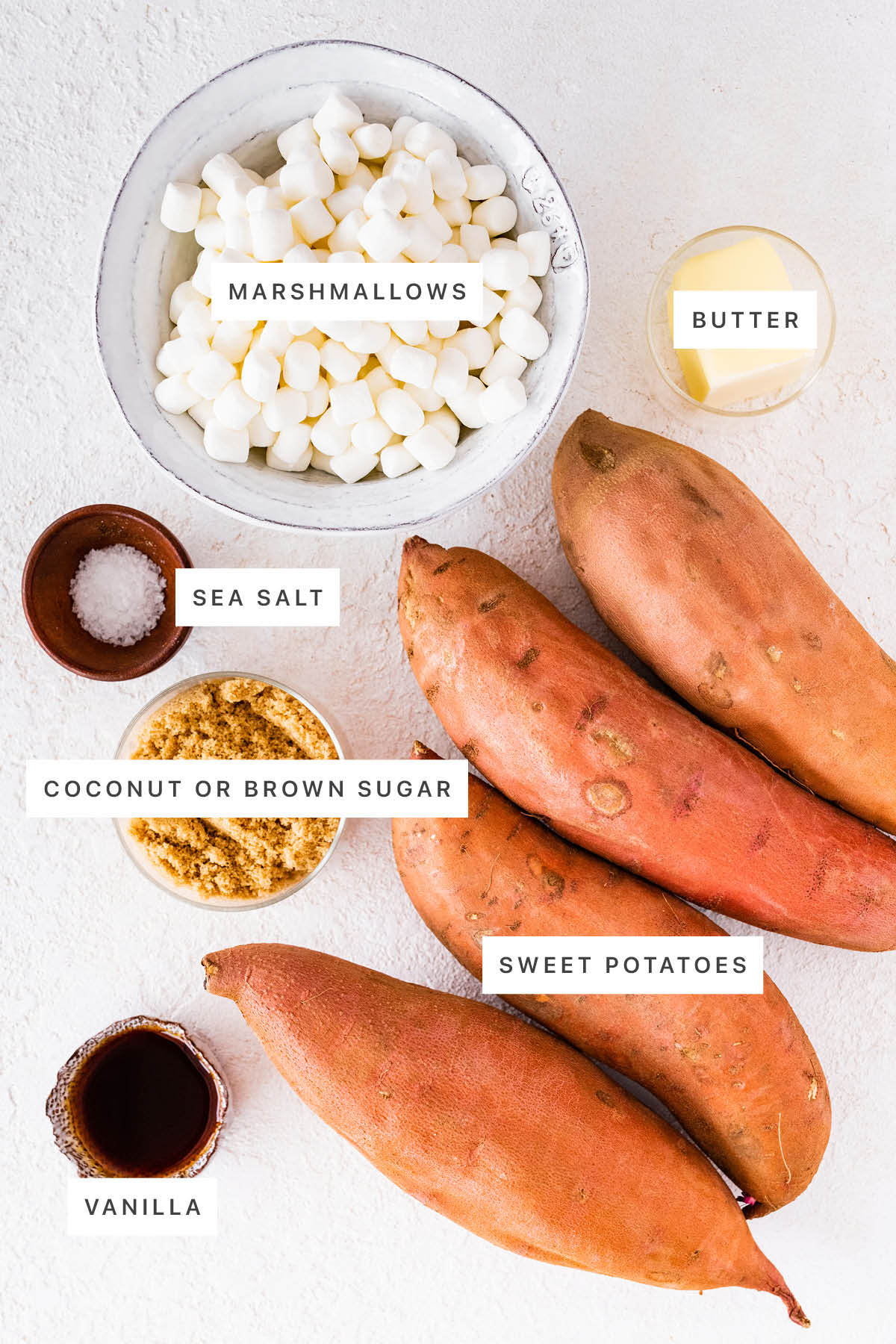 Ingredients measured out to make Classic Sweet Potato Casserole: marshmallows, butter, sea salt, coconut or brown sugar, sweet potatoes and vanilla.