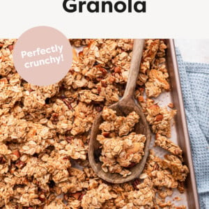 Homemade Granola on a pan with a wood spoon.