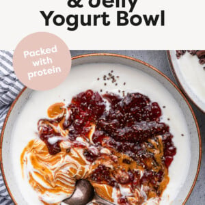 Peanut Butter & Jelly Yogurt Bowl topped with peanut butter and strawberry chia seed jam.