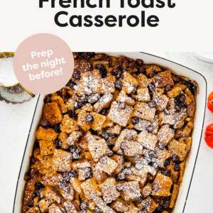 Pumpkin French Toast Casserole in a dish topped with chocolate chips and powder sugar.