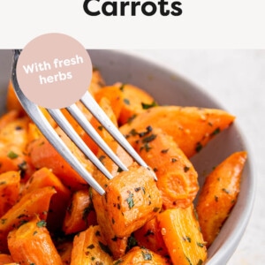 Bowl of Roasted Carrots. A fork has one carrot.