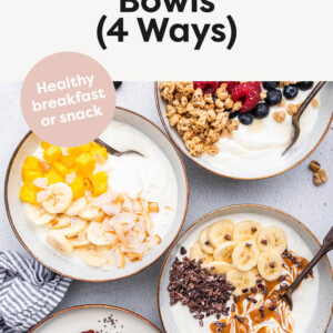 Four different yogurt bowls with various fruit and nut butter toppings.