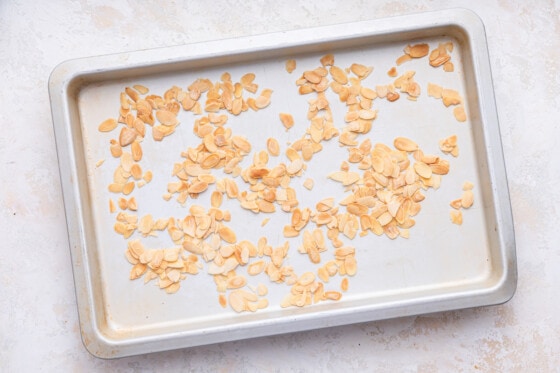 Toasted slivered almonds on a baking tray.