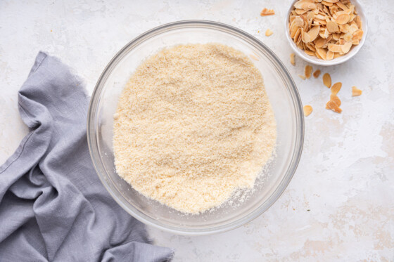 A glass bowl containing the dry ingredients used for an almond cake.