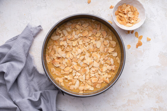 Almond cake batter in a cake pan before being baked.