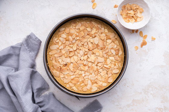 Almond cake in a cake pan after being baked.