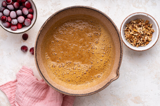 Wet ingredients in a large mixing bowl used for the cranberry banana bread.