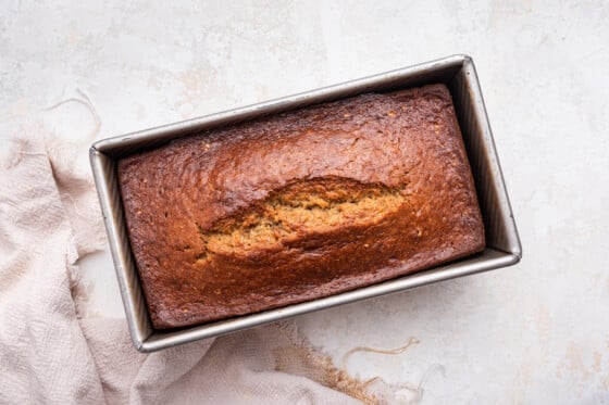 Banana bread after being baked in a loaf pan.