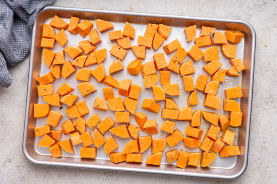 Cubed sweet potatoes on a baking tray.