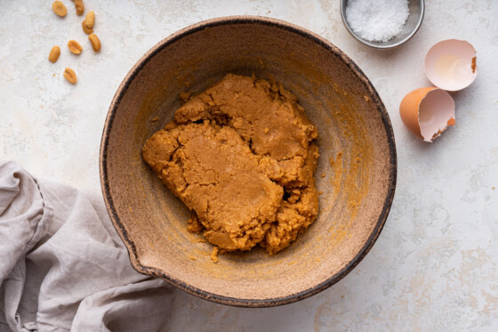 The dough for peanut butter cookies mixed together in a bowl.