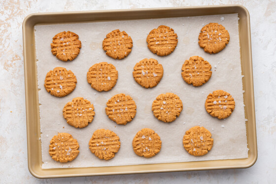 Baked peanut butter cookies on a baking sheet.