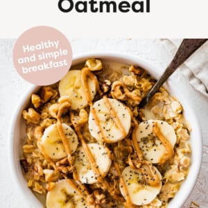 Bowl of oatmeal topped with chia seeds, walnuts, peanut butter and banana.