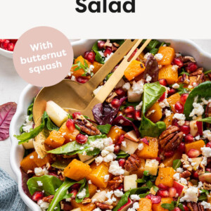 Photo of a bowl with Winter Salad topped with nuts, feta and fruit.