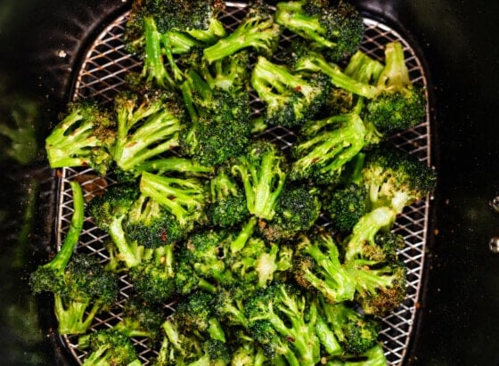 Seasoned air-fried broccoli in an air fryer.