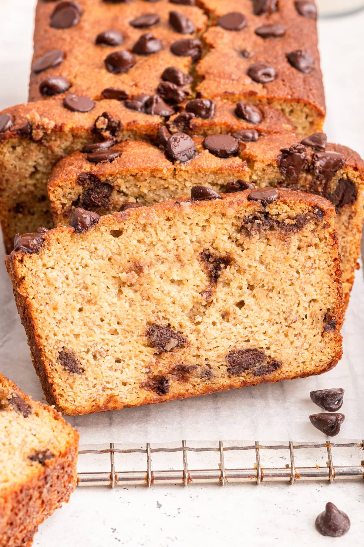 Almond flour banana bread with chocolate chips, on a wire rack.