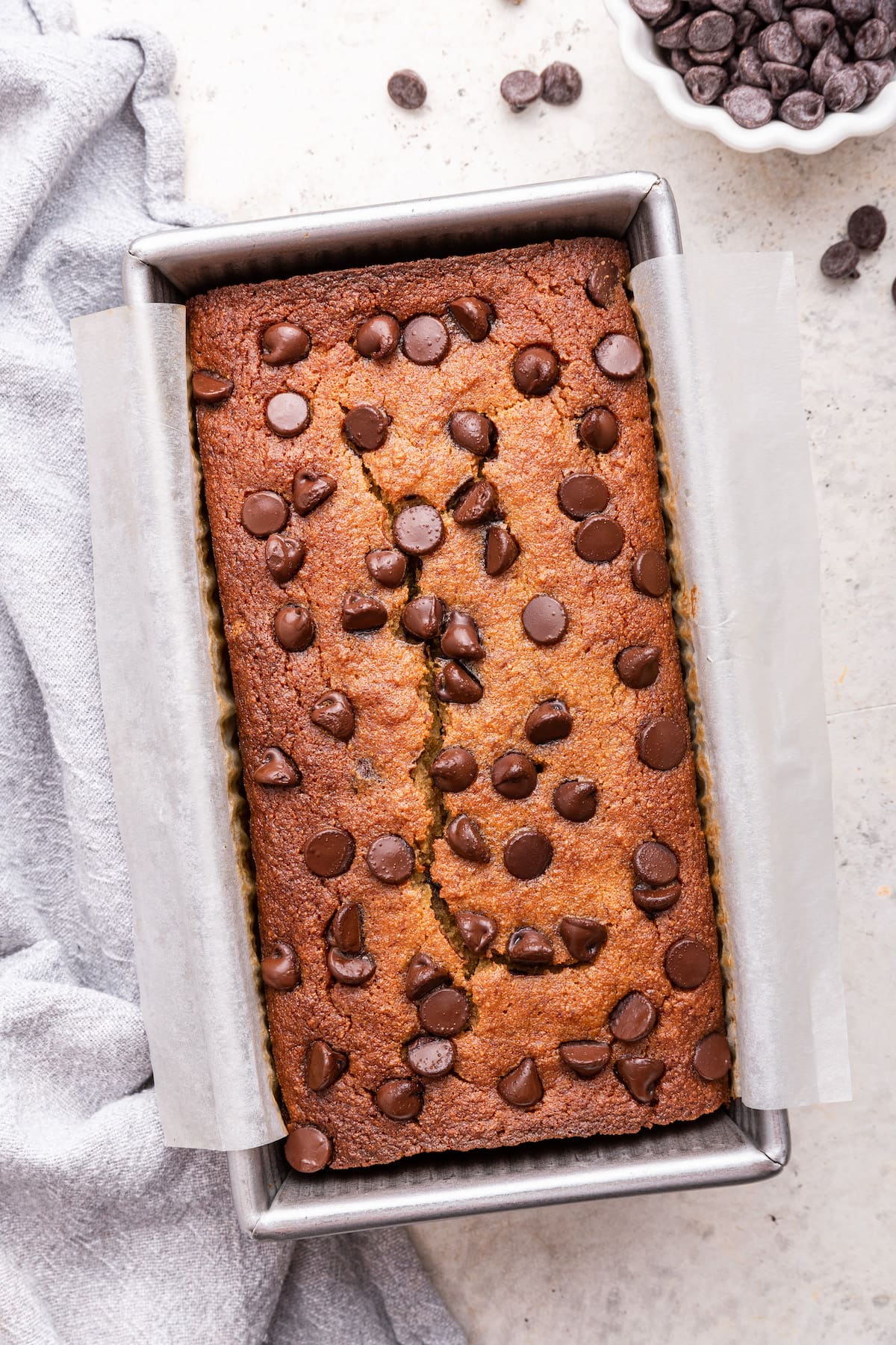 Almond flour banana bread with chocolate chips in a bread pan.