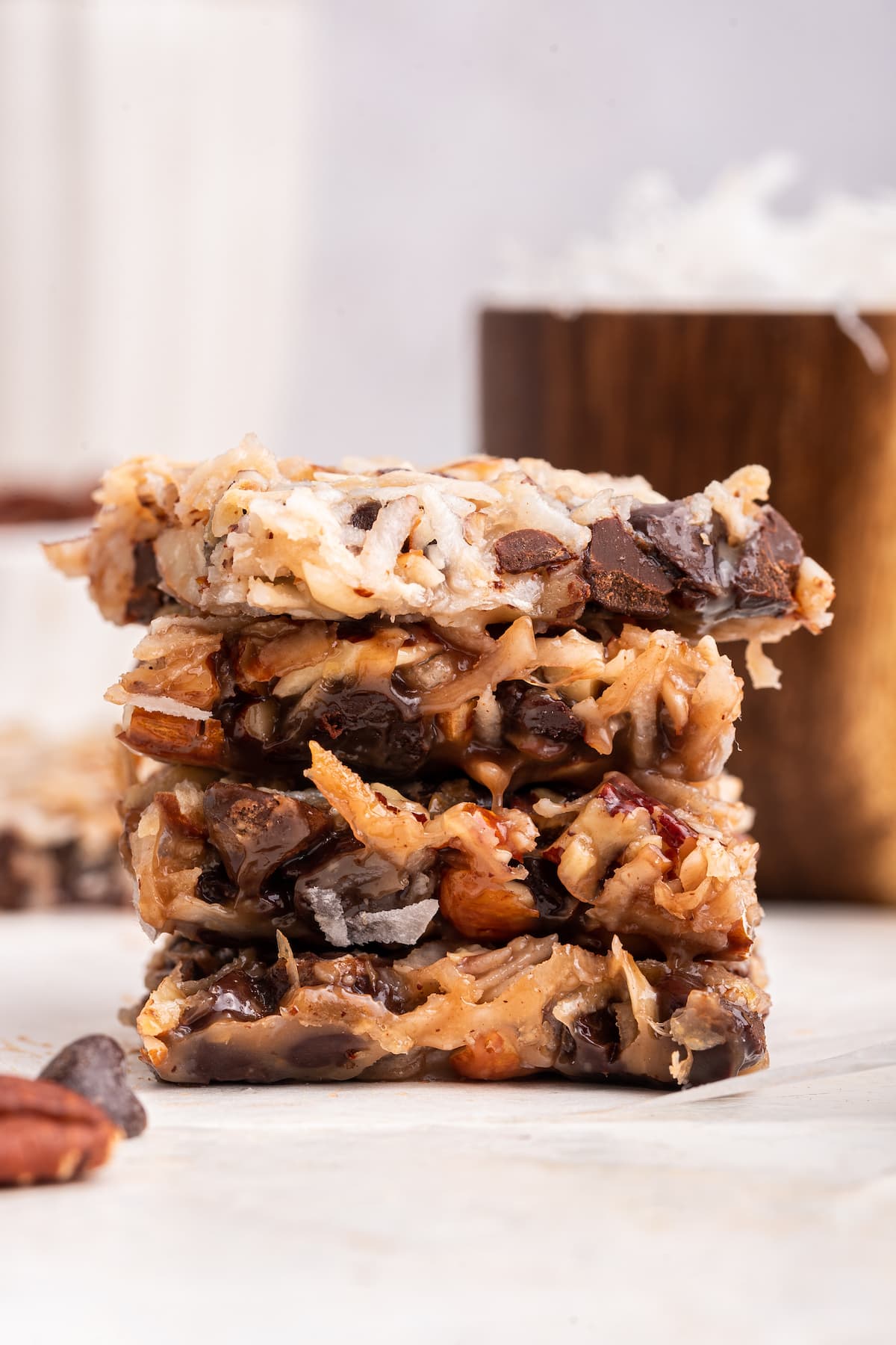 Four chocolate coconut bars stacked on one another.