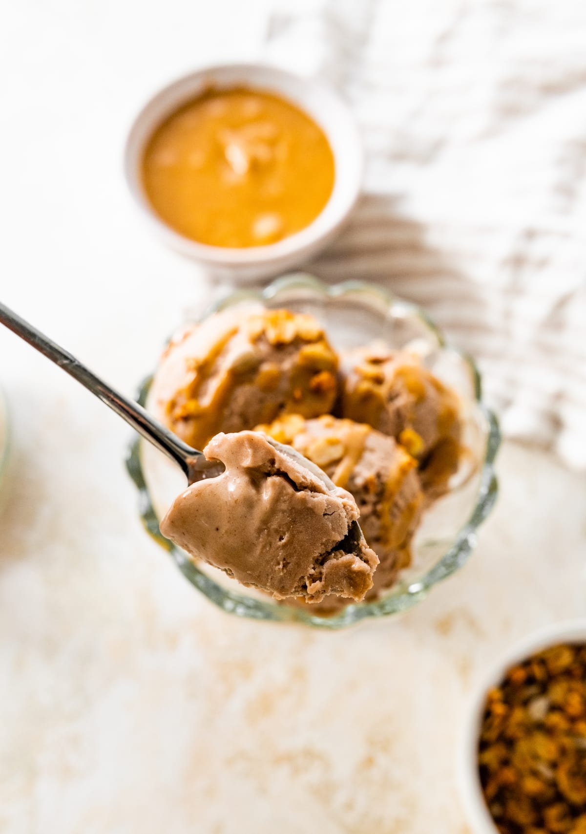 A spoon with a bite of chocolate peanut butter protein icee cream.