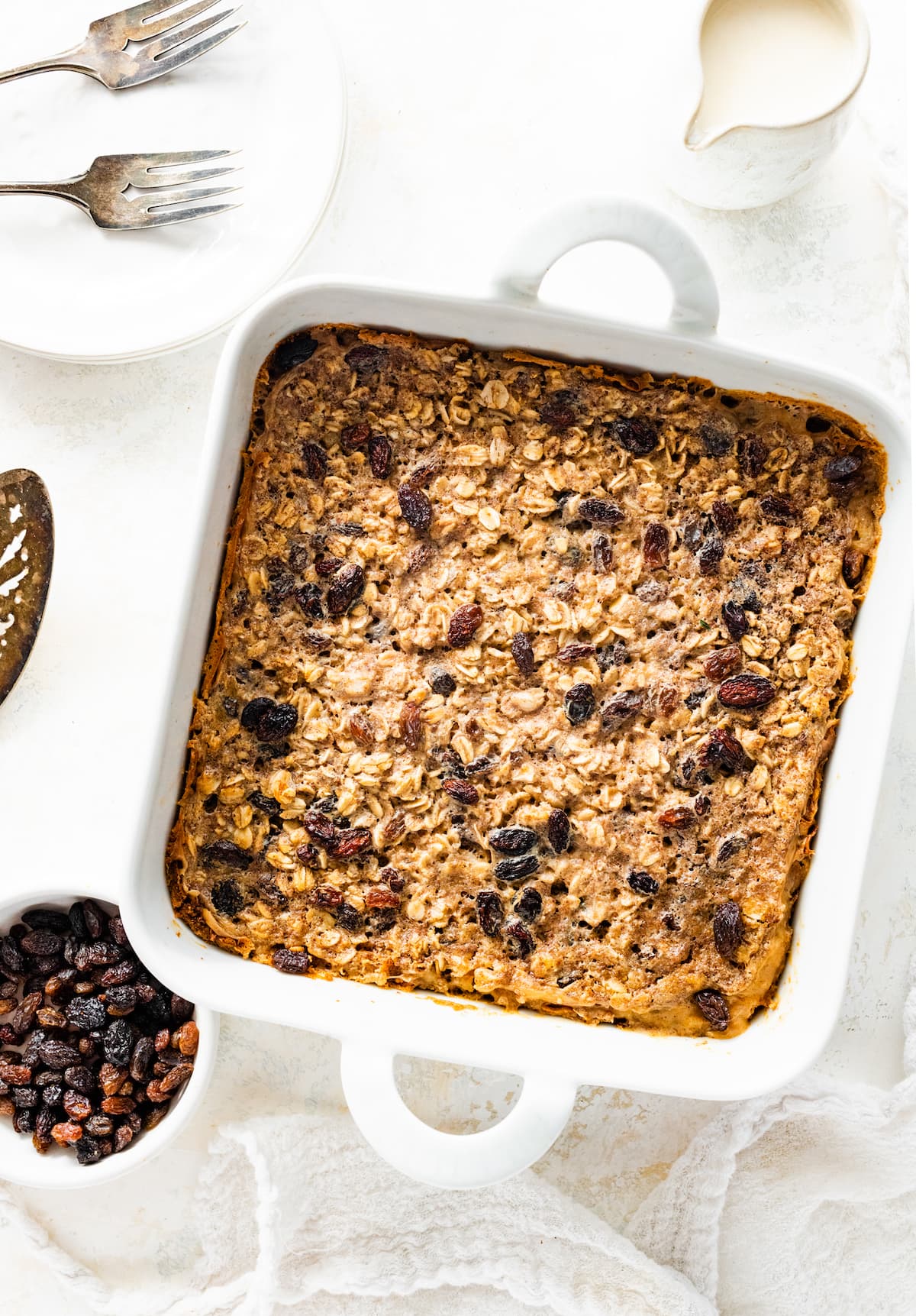 Cinnamon raisin baked oatmeal in a square baking dish.