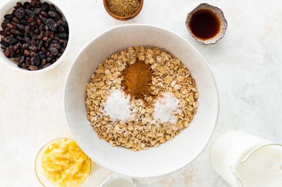 Rolled oats, ground cinnamon, salt, and baking powder in a large mixing bowl.