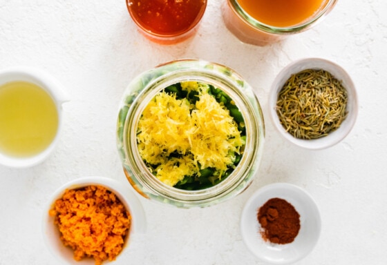 Ingredients being prepped in a large mason jar that will be used to make a fire cider.